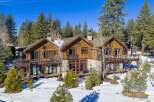 Nestled amidst a serene, snow-covered landscape, this stunning property boasts a blend of rustic charm and modern elegance.