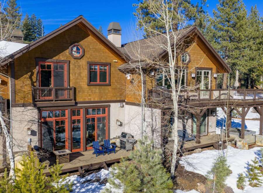 This stunning mountain home boasts a beautiful exterior with a combination of wood and stone accents.