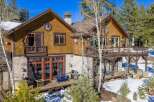 This stunning mountain home boasts a beautiful exterior with a combination of wood and stone accents.