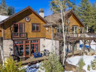 This stunning mountain home boasts a beautiful exterior with a combination of wood and stone accents.