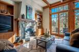 Experience the warmth of this stunning living room, featuring a cozy fireplace and elegant wooden accents.