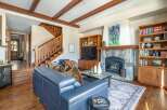 This stunning living room boasts a cozy fireplace, perfect for chilly evenings.