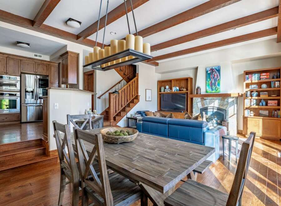 This stunning property boasts a spacious living area with a cozy fireplace and a modern kitchen.