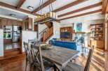 This stunning property boasts a spacious living area with a cozy fireplace and a modern kitchen.