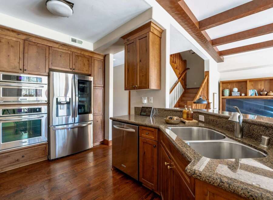 This stunning kitchen boasts top-of-the-line stainless steel appliances, including a refrigerator, oven, and microwave.