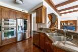 This stunning kitchen boasts top-of-the-line stainless steel appliances, including a refrigerator, oven, and microwave.