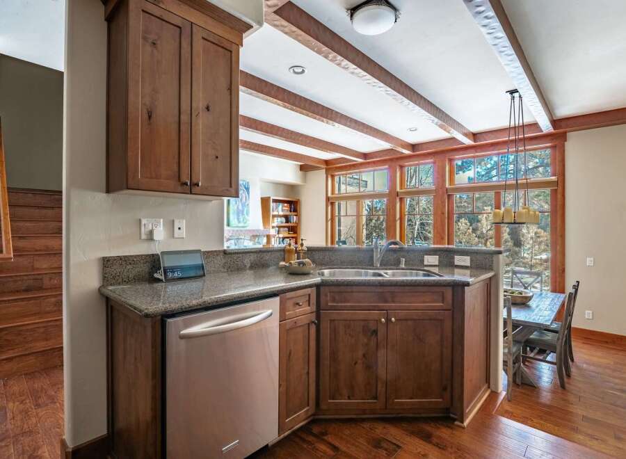 This stunning kitchen boasts custom cabinetry, granite countertops, and stainless steel appliances.