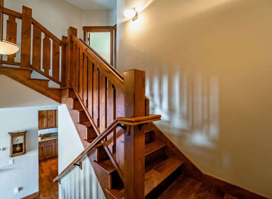 This stunning property features a beautifully crafted wooden staircase, adding a touch of elegance and warmth to the interior.