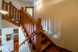 This stunning property features a beautifully crafted wooden staircase, adding a touch of elegance and warmth to the interior.