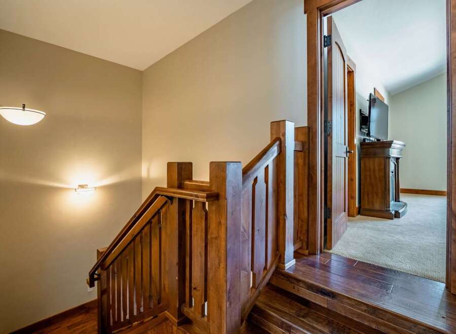This stunning property features a beautifully crafted wooden staircase, adding warmth and character to the home.