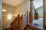 This stunning property features a beautifully crafted wooden staircase, adding warmth and character to the home.