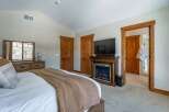 This luxurious bedroom features a cozy fireplace, perfect for relaxing on chilly evenings.