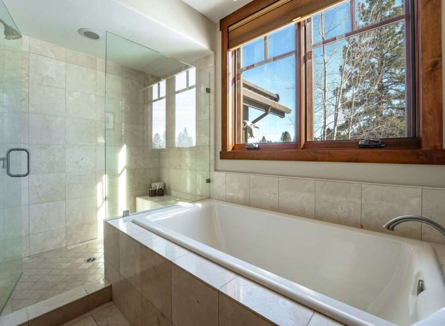 This luxurious bathroom features a modern design with a spacious walk-in shower and a relaxing soaking tub.