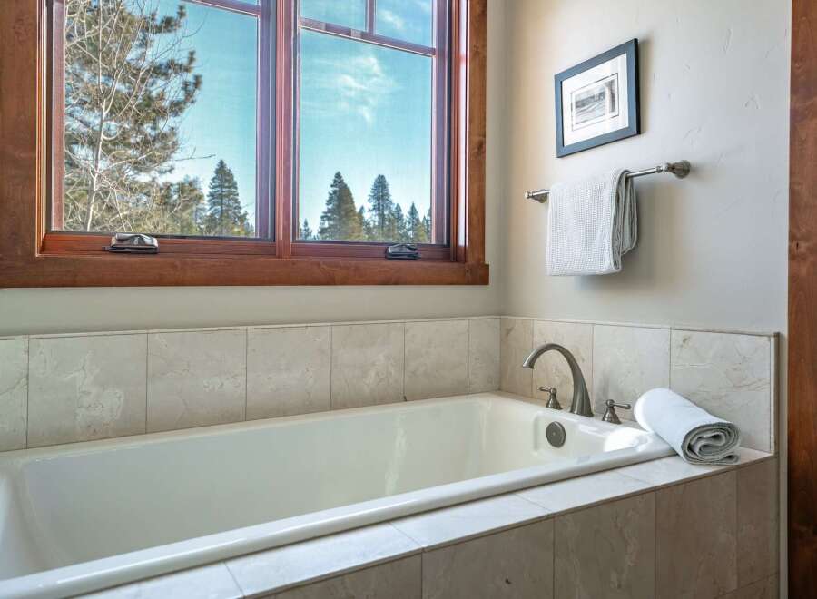 Enjoy the tranquility of this bathroom featuring a luxurious soaking tub, perfect for unwinding after a long day.