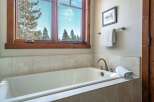 Enjoy the tranquility of this bathroom featuring a luxurious soaking tub, perfect for unwinding after a long day.