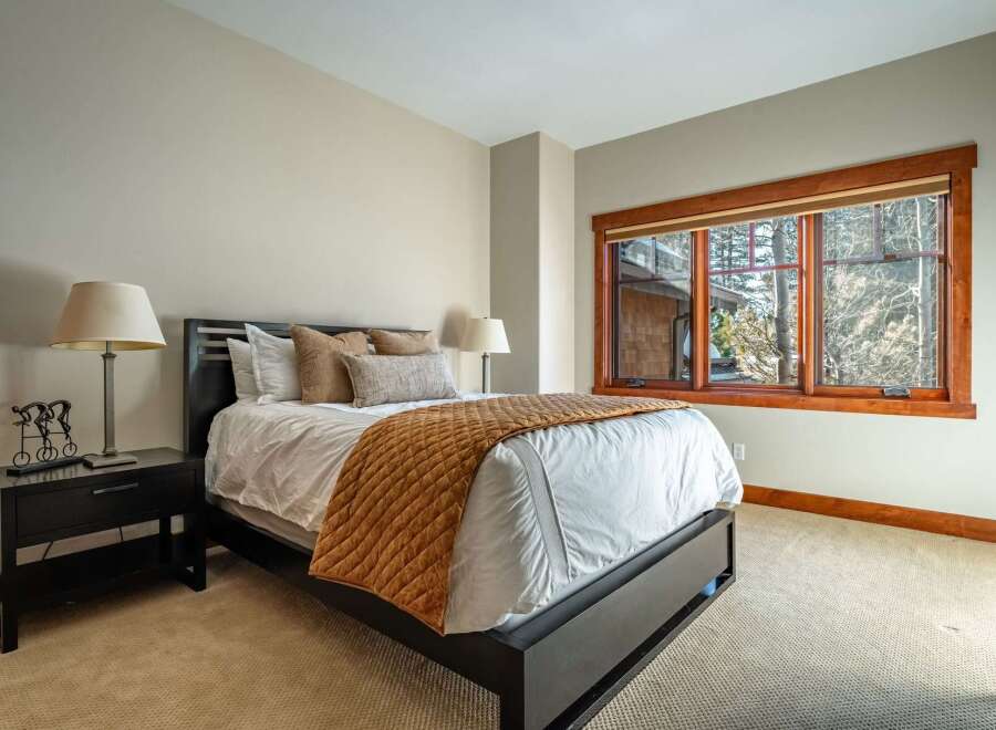 This inviting bedroom features a comfortable bed with a stylish quilt, perfect for a relaxing retreat.