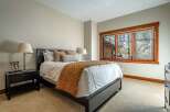 This inviting bedroom features a comfortable bed with a stylish quilt, perfect for a relaxing retreat.