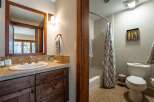 This beautiful bathroom features a stylish vanity with a large mirror and ample storage.