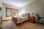 This inviting bedroom features a cozy bed with plush pillows and a warm, inviting throw.