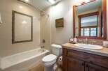 This beautiful bathroom features a modern design with a sleek white bathtub and a stylish vanity.