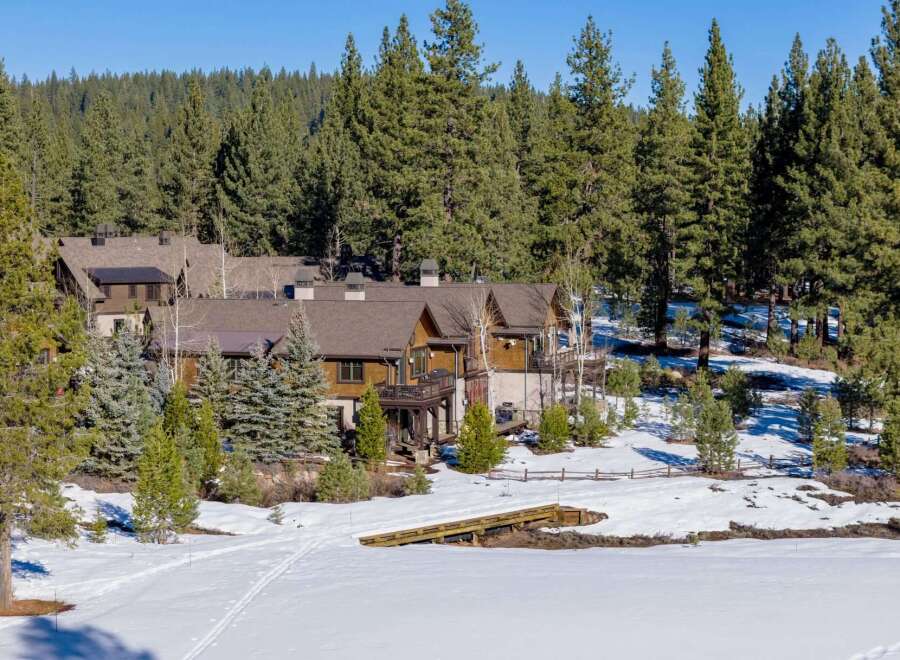 Nestled amidst a serene winter landscape, this stunning property boasts a blend of rustic charm and modern elegance.