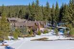 Nestled amidst a serene winter landscape, this stunning property boasts a blend of rustic charm and modern elegance.