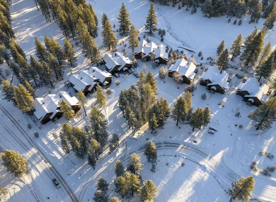 Nestled amidst a snowy landscape, this stunning property showcases a collection of charming homes.