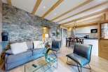 Experience rustic elegance in this stunning property, featuring a striking stone wall that adds character and charm.