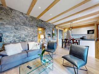 Experience rustic elegance in this stunning property, featuring a striking stone wall that adds character and charm.
