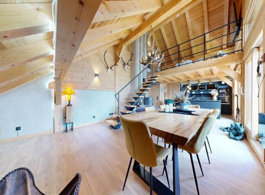 Experience luxury living in this stunning chalet-style property, boasting a unique architectural design with exposed wooden beams and a loft area.