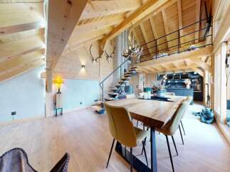 Experience luxury living in this stunning chalet-style property, boasting a unique architectural design with exposed wooden beams and a loft area.