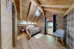 Experience the charm of this cozy bedroom, featuring a rustic wooden interior and a comfortable bed.