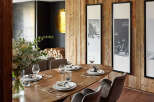 Experience luxury living in this stunning dining room, featuring a beautiful wooden table and stylish chairs.