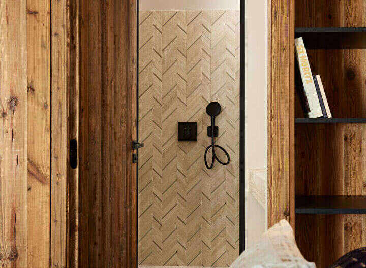 Step into luxury with this stunning property featuring exquisite wooden accents and a unique herringbone-patterned door.