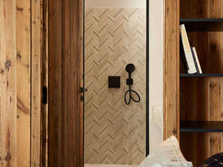 Step into luxury with this stunning property featuring exquisite wooden accents and a unique herringbone-patterned door.