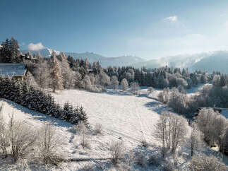 Nestled in a serene winter wonderland, this property offers breathtaking views of snow-covered landscapes and majestic mountains.