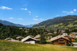 Experience the charm of alpine living in this picturesque village nestled amidst rolling green hills and majestic mountains.