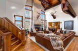 Step into luxury with this stunning property featuring a grand living room with a stone fireplace and soaring ceilings.