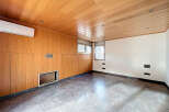 Discover the elegance of this stunning room, featuring exquisite wood paneling and a sleek, modern design.