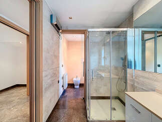 Step into this modern bathroom, featuring a sleek glass shower enclosure and contemporary design.