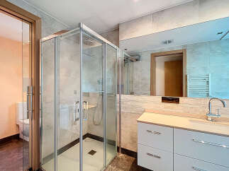 Step into luxury with this stunning bathroom! Featuring a modern glass shower, sleek white cabinetry, and a large mirror, this space is designed for both style and functionality.