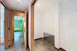 Step into this inviting hallway, showcasing a modern design with sleek wooden doors and elegant flooring.