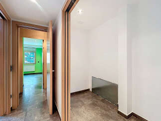 Step into this inviting hallway, showcasing a modern design with sleek wooden doors and elegant flooring.