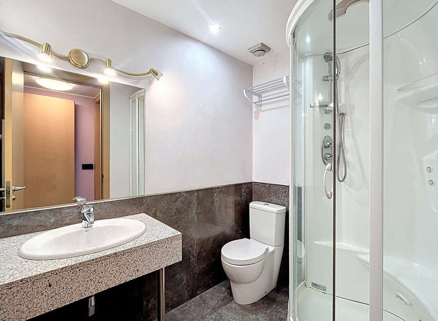 Step into this modern bathroom featuring a sleek design and contemporary fixtures.