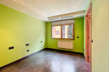 Discover this inviting room featuring a vibrant green wall that adds a touch of freshness.