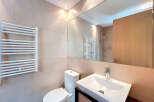 This modern bathroom features a sleek design with neutral tones and high-end finishes.