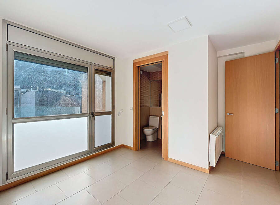 This bright and airy room features large windows that offer stunning views and ample natural light.