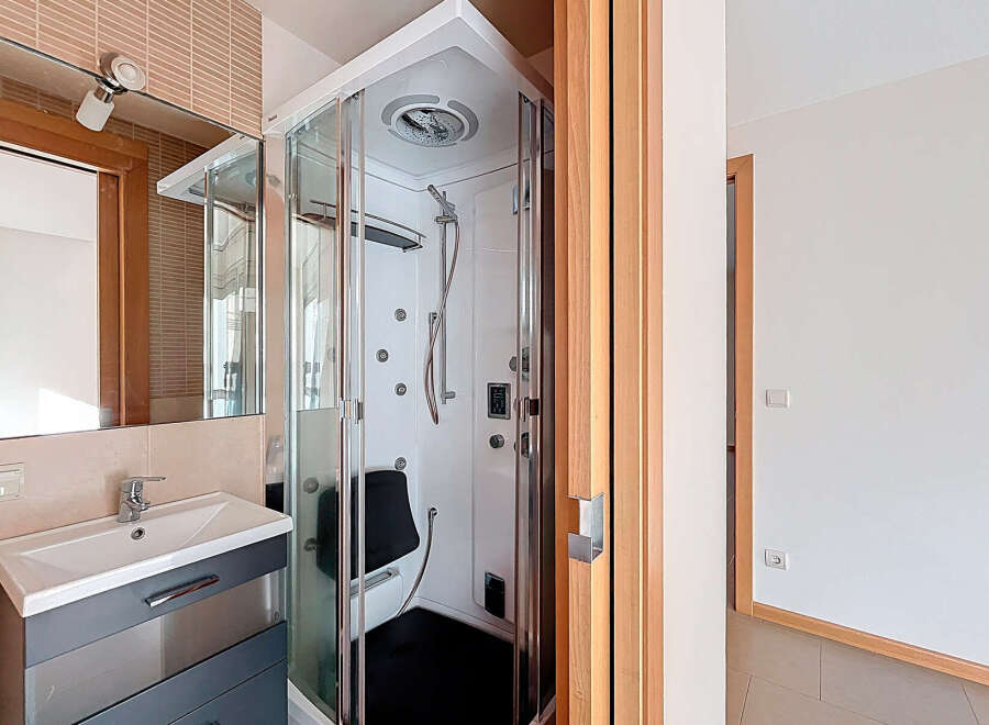 Step into a modern bathroom oasis! This property boasts a luxurious shower cabin, perfect for unwinding after a long day.