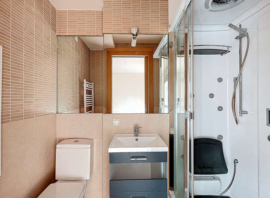 This modern bathroom features a sleek design with a combination of functionality and style.
