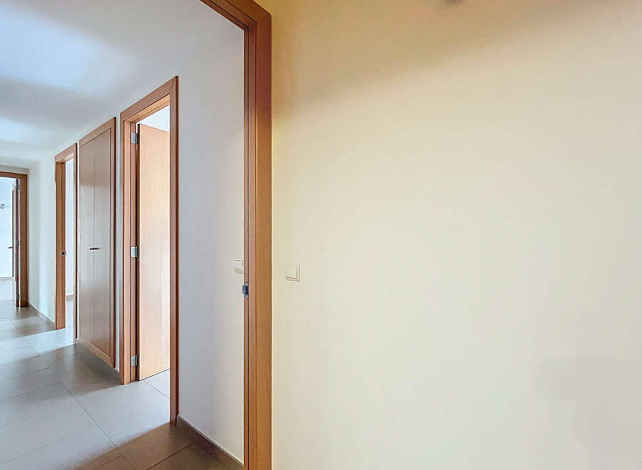 Discover the charm of this inviting hallway, featuring multiple doors leading to various rooms.